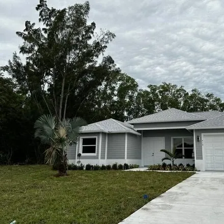 Rent this 4 bed house on 423 Southwest Namboit Place in Port Saint Lucie, FL 34953