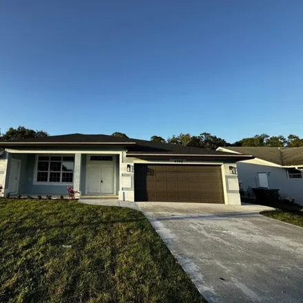 Buy this 4 bed house on 5028 Northwest Flintstone Avenue in Port Saint Lucie, FL 34983