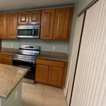 Rent this 2 bed townhouse on Kingston Court in West Palm Beach, FL 33409