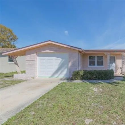 Buy this 3 bed house on 7423 Castanea Drive in Jasmine Estates, FL 34668