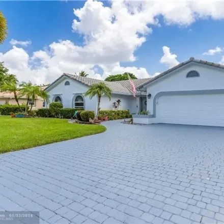 Rent this 4 bed house on 8648 NW 57th Ct in Coral Springs, Florida