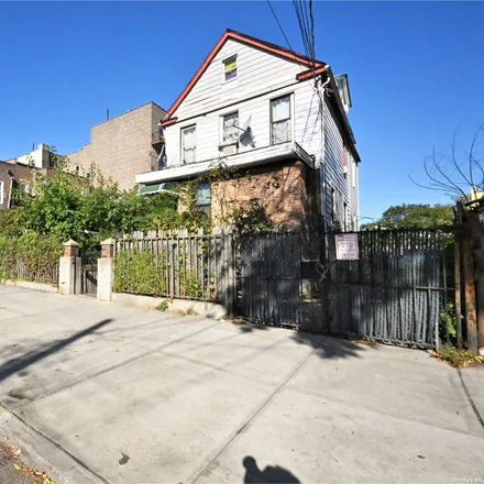Buy this 5 bed townhouse on 34-41 100th Street in New York, NY 11368