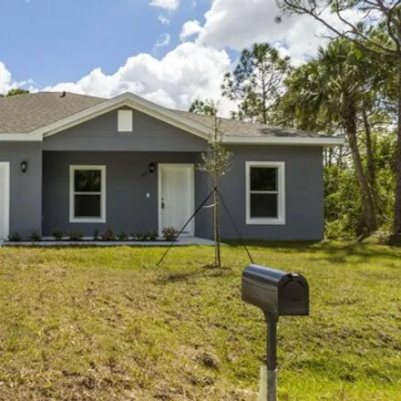 Rent this 4 bed house on 1086 Tetzel Street Southeast in Palm Bay, FL 32909
