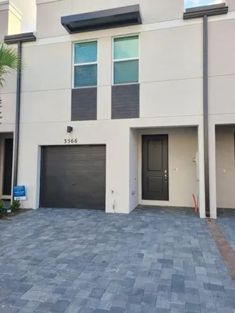 Rent this 3 bed townhouse on 4098 Coconut Road in Lake Worth Corridor, Palm Springs