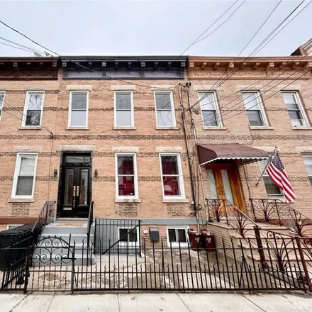 Buy this 6 bed house on 74-27 64th Place in New York, NY 11385