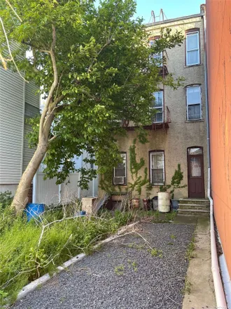 Buy this 9 bed townhouse on 60-03 56th Road in New York, NY 11378