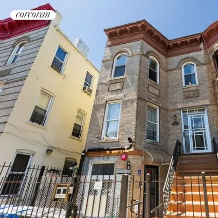 Buy this 8 bed townhouse on 215 Schaefer Street in New York, NY 11207