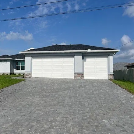 Rent this 4 bed house on Northeast 10th Place in Cape Coral, FL