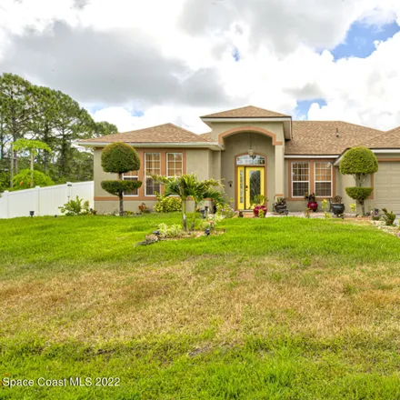 Buy this 4 bed house on 1499 Tharp Road Southeast in Palm Bay, FL 32909