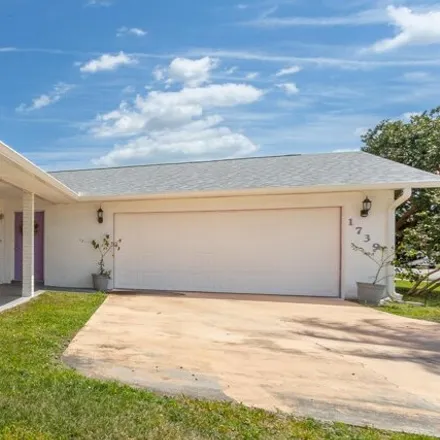 Buy this 3 bed house on 1723 Biddle Street Northeast in Palm Bay, FL 32907
