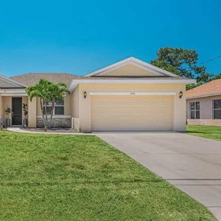 Buy this 3 bed house on 1244 Southwest Ermine Avenue in Port Saint Lucie, FL 34953