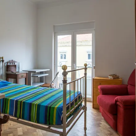 Rent this 4 bed room on Rua Doutor Álvaro de Castro in 1600-069 Lisbon, Portugal