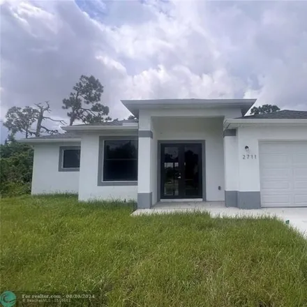 Rent this 4 bed house on 2711 SW 4th St in Lehigh Acres, Florida