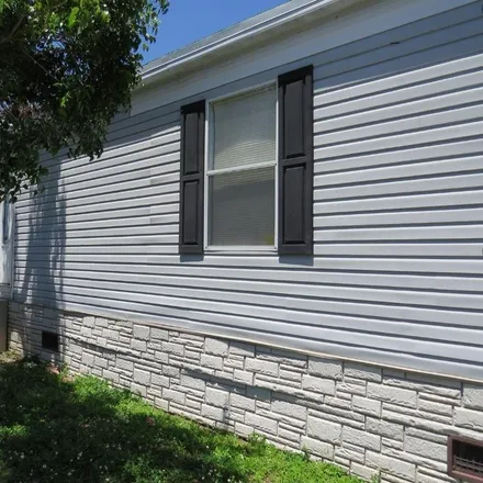 Rent this 4 bed house on 105 Northeast 12th Avenue in Four Seasons Mobile Home Park, Homestead
