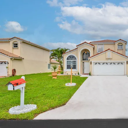 Rent this 3 bed house on 142 Woodlake Circle in Park Pointe, Greenacres
