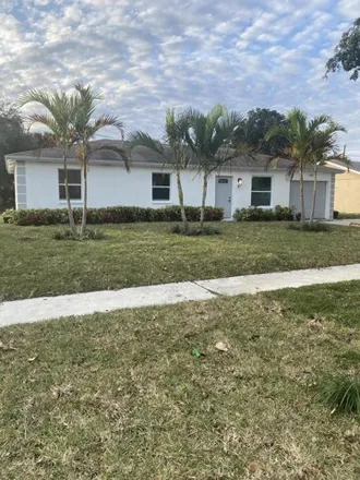 Buy this 3 bed house on 1487 North Mangonia Drive in Palm Beach Lakes, West Palm Beach
