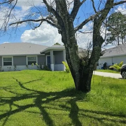 Rent this 3 bed house on 319 Bell Blvd S in Lehigh Acres, Florida