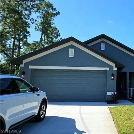 Rent this 3 bed house on 967 Macy Street in Lehigh Acres, FL 33974